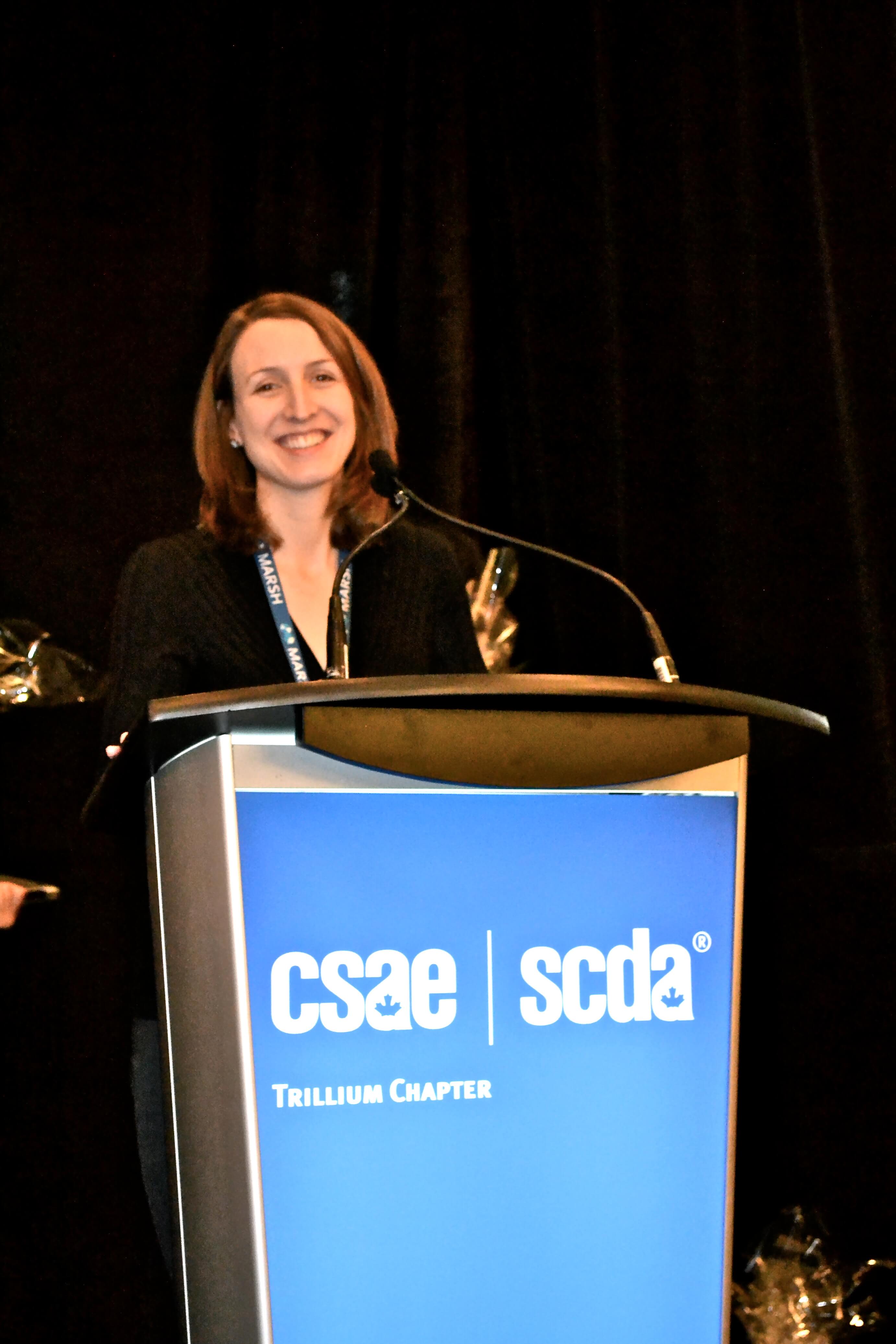 Laura Sellors at the CSAW podium discussing C ( Group's development of a website strategy