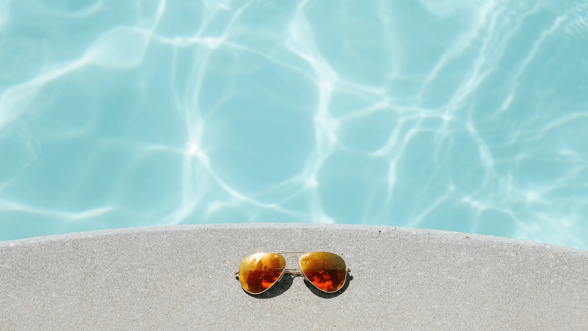 This image displays a pool and sun glasses and portrays relevance to branding and strategic communications for nonprofit fundraising