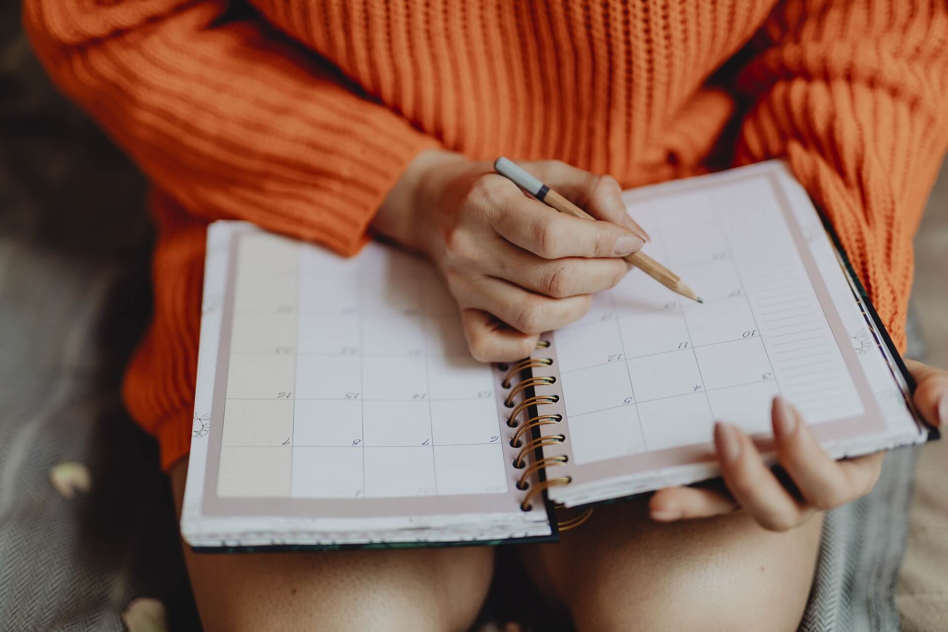 Woman writing on a calendar